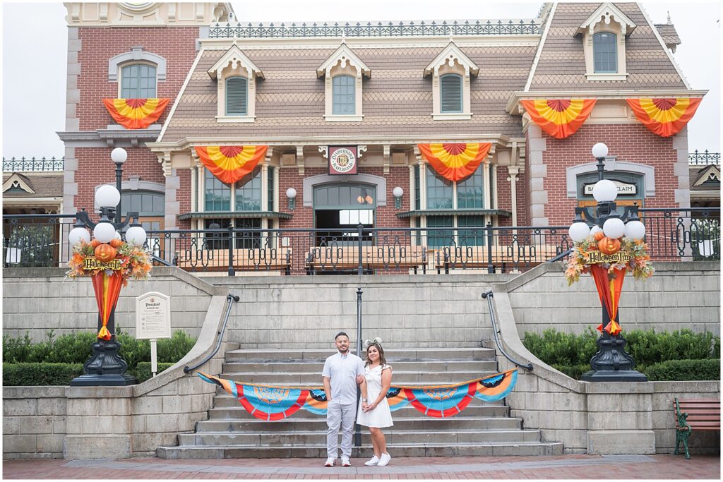 Disneyland engagement photos in front of the train station